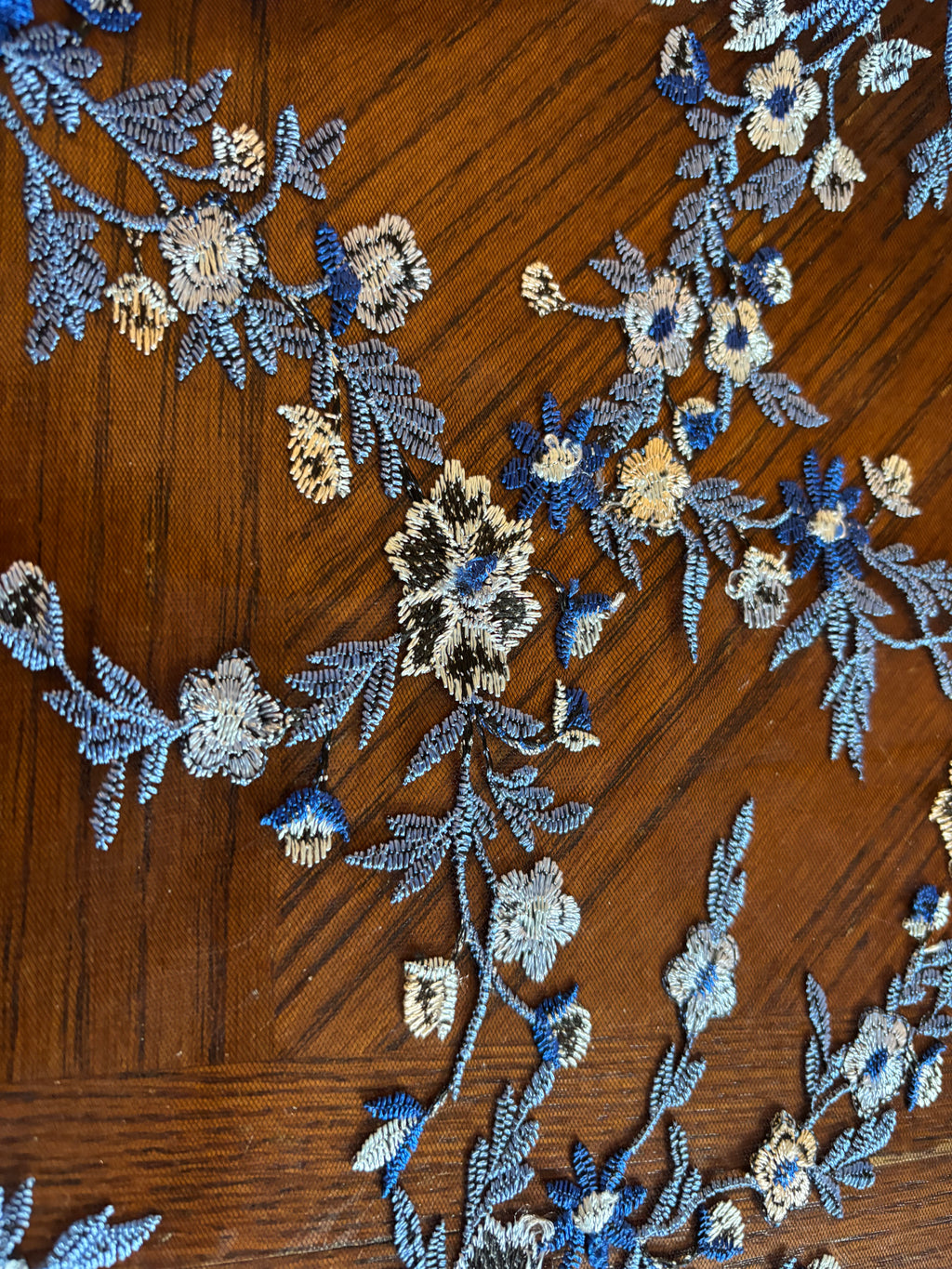 SHADES OF BLUE EMBROIDERED LACE ON BLACK MESH FABRIC