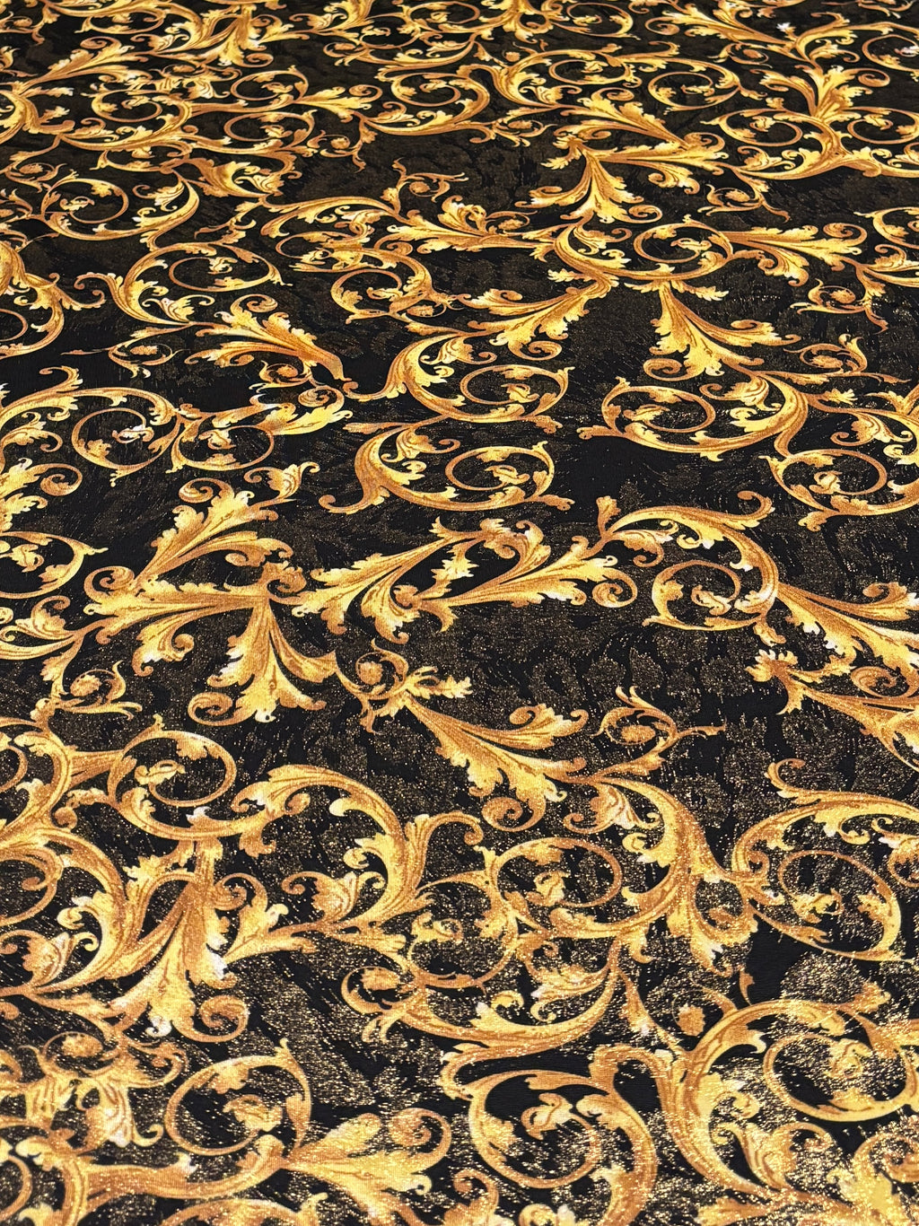 GOLD SCROLLS ON BLACK BACKGROUND